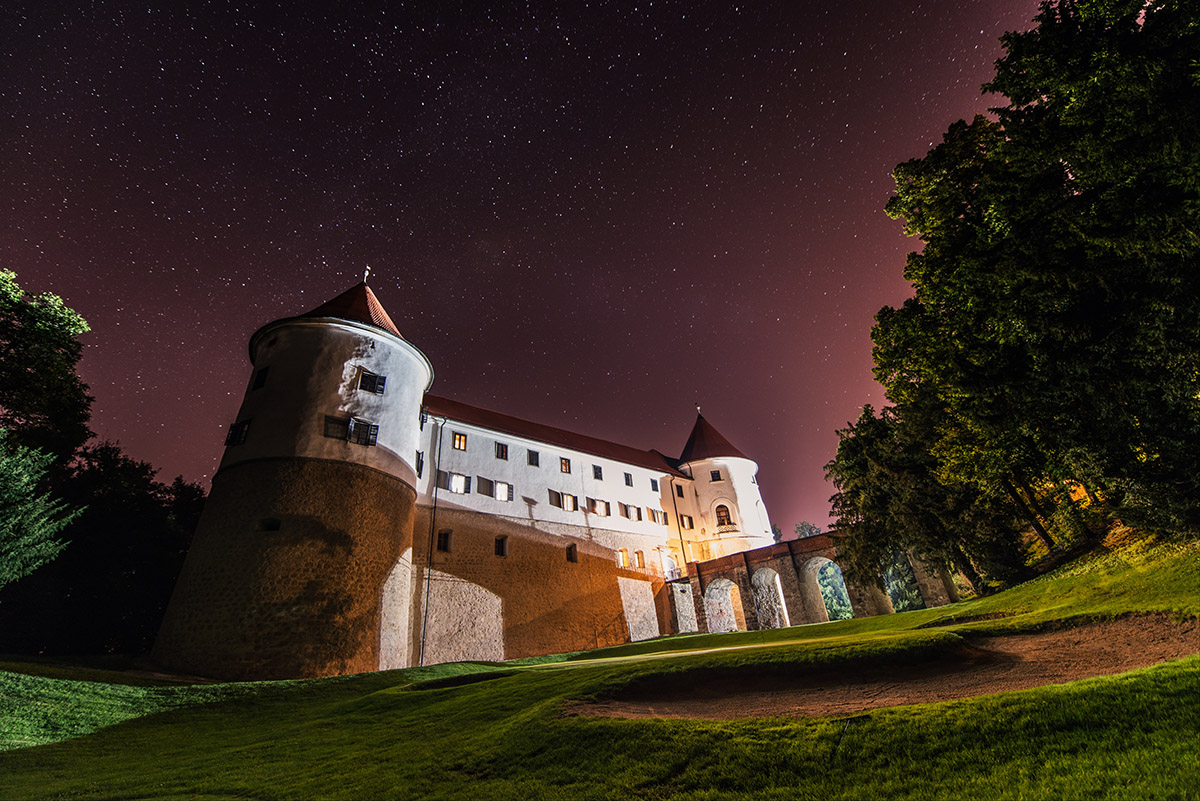 Mokrice castle at night with a starry night above. Dark and peaceful atmosphere under milky way.